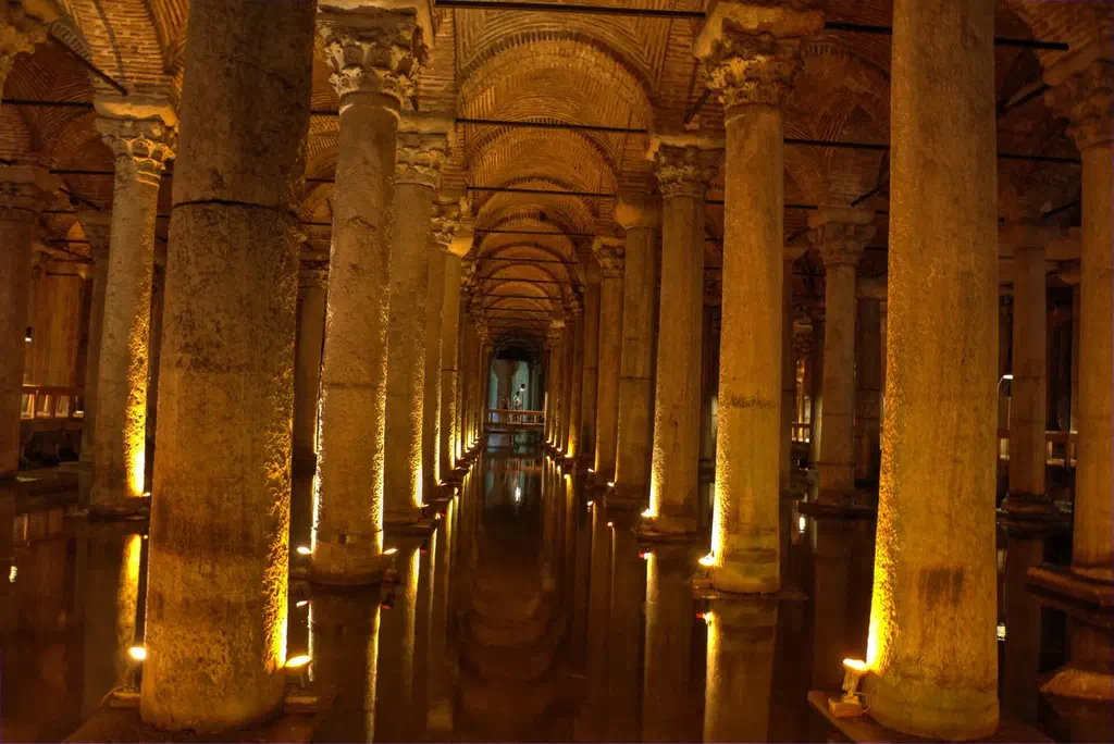 The cool, dimly lit stone columns and reflecting water inside the Basilica Cistern in Istanbul