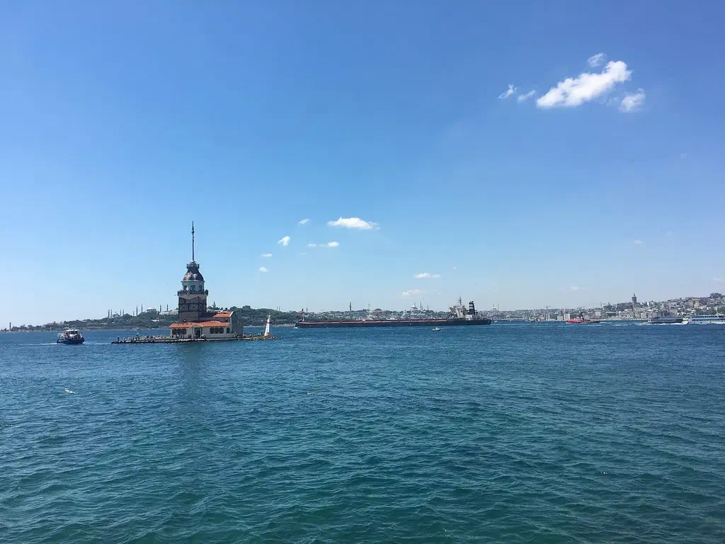Sunrise over the Maiden's Tower seen from the Salacak promenade in Üsküdar, with the Historic Peninsula skyline behind