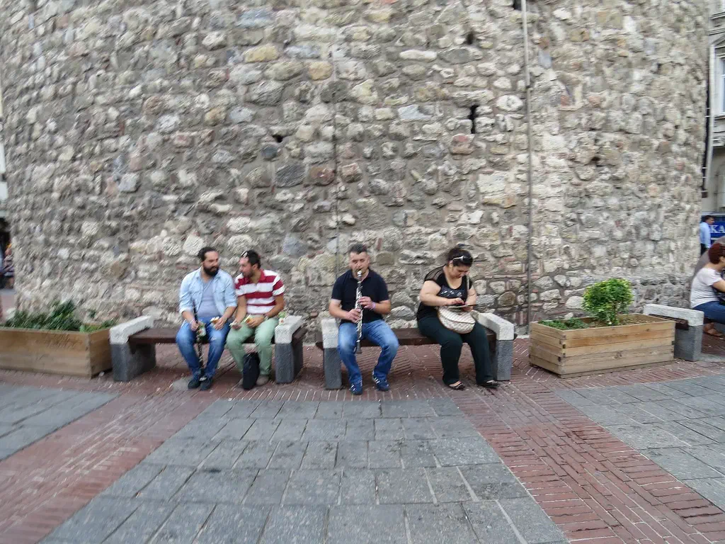 Street musicians playing on the cobbled square at the foot of Galata Tower