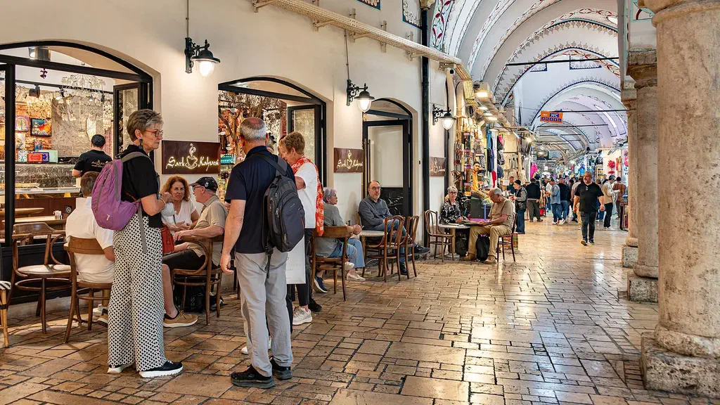A painted arched corridor of the Grand Bazaar in Istanbul lined with shops