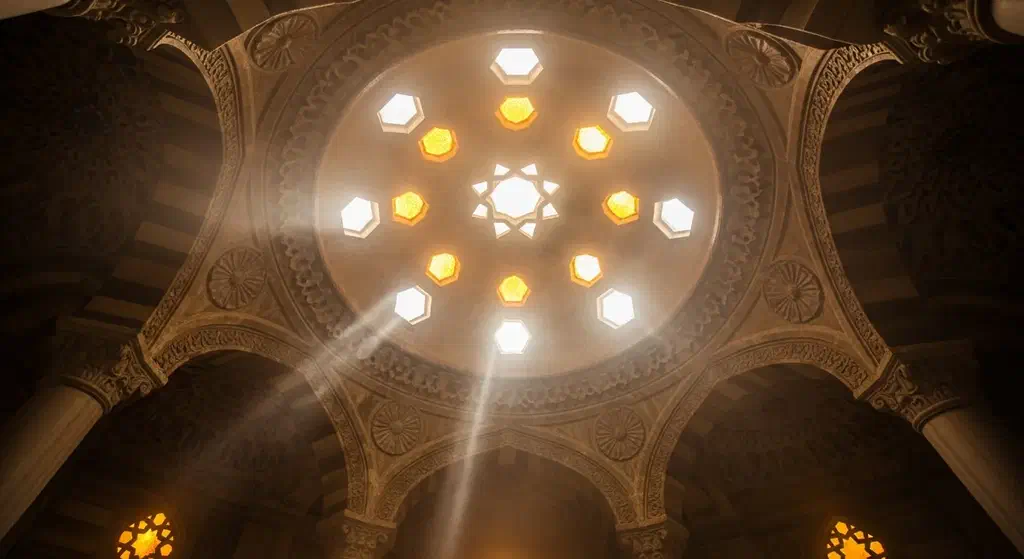 Looking up at a Turkish hammam dome with star-shaped glass light holes glowing through the steam