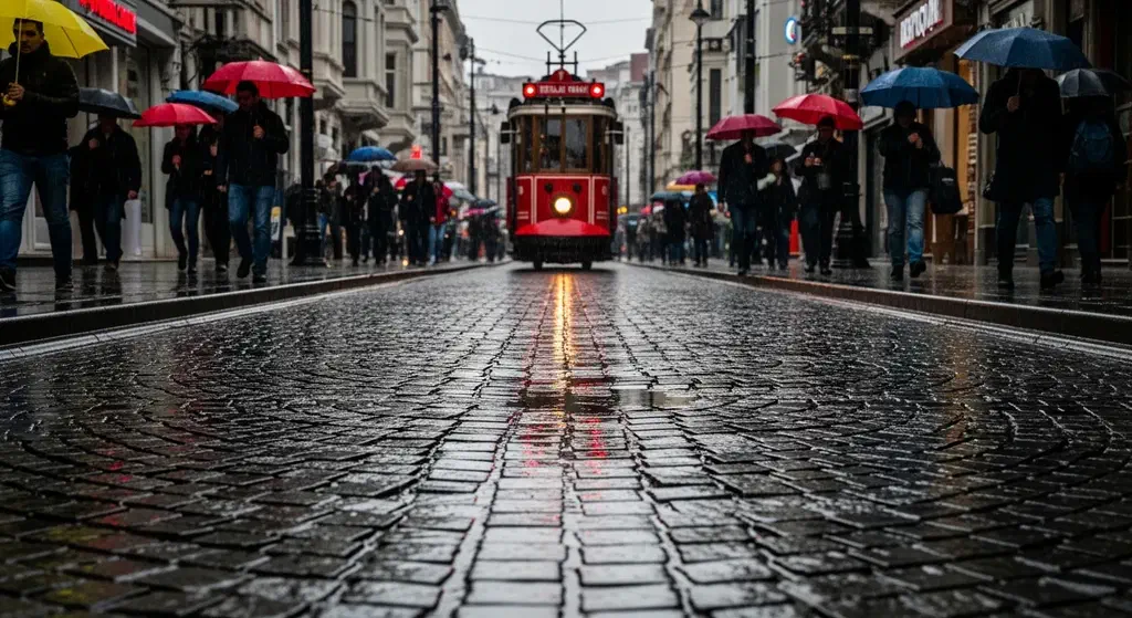 A rainy cobblestone street in Istanbul with wet reflections and colourful umbrellas