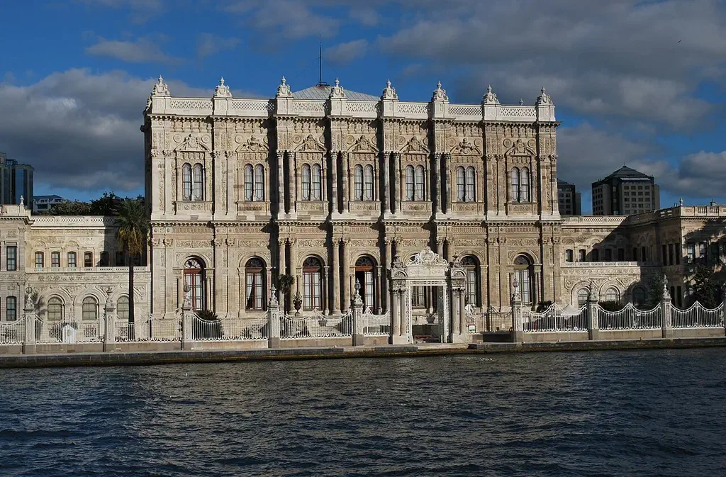 The long white marble facade of Dolmabahce Palace seen from the Bosphorus waterfront