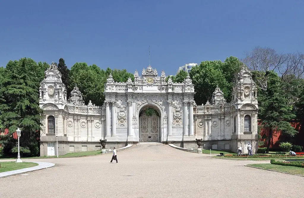 The ornate baroque Treasury Gate of Dolmabahce Palace with its clock tower